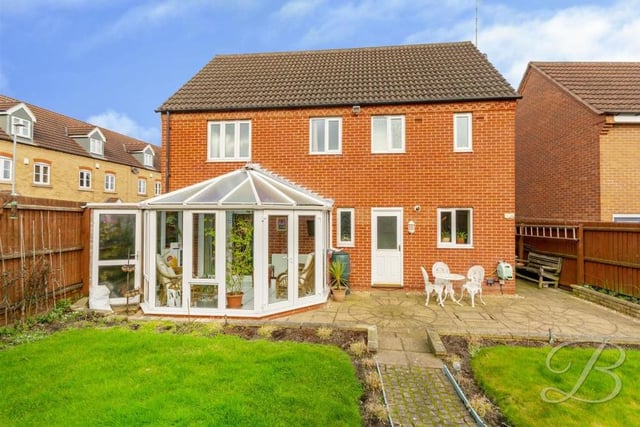 Let's step outside now and take a look at the Spindle Court property from the rear. The photo shows the conservatory, the private and enclosed back garden and also the lovely patio area with seating.