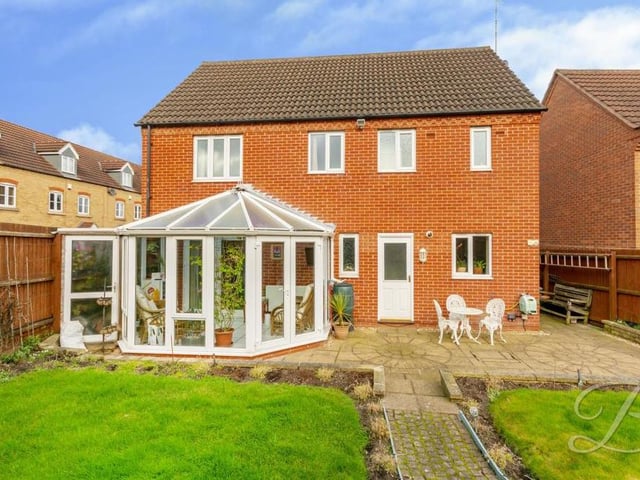 Let's step outside now and take a look at the Spindle Court property from the rear. The photo shows the conservatory, the private and enclosed back garden and also the lovely patio area with seating.