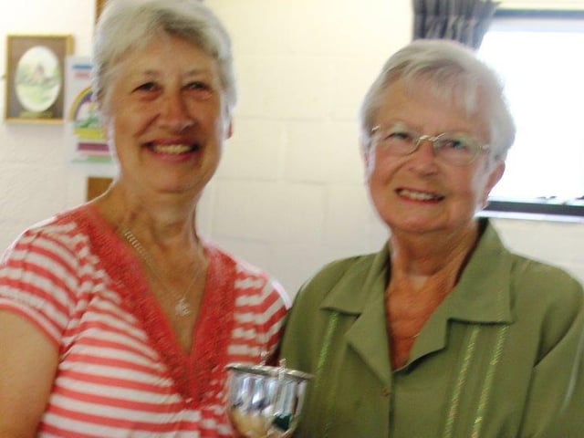 Elaine Cordingley being presented with her trophy by vice-president Stella Whitelock
