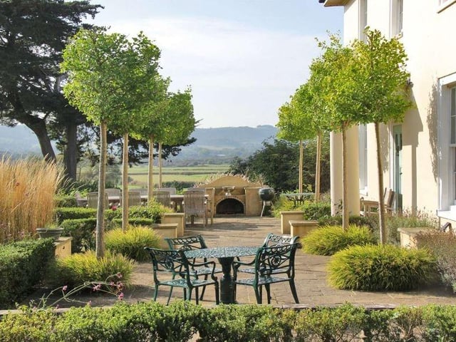 To the south of the house is a beautiful York stone terrace, edged by lavender and box, with two avenues of young ginkgo trees and a brick-built pizza oven