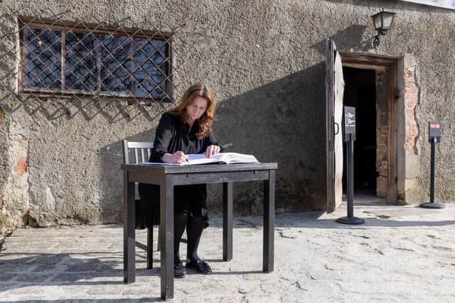 Gillian Keegan signs a book of remembrance at former concentration camp Auschwitz-Birkenau.