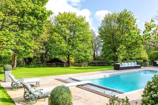 This five bed detached house is on the market for a guide price of £2,250,000 with Savills - Haywards Heath.
Located at the end of a private country lane near to the centre of the village, it has established landscaped gardens with swimming pool and a rural outlook.