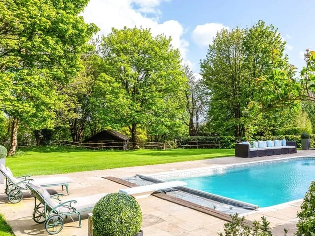 This five bed detached house is on the market for a guide price of £2,250,000 with Savills - Haywards Heath.
Located at the end of a private country lane near to the centre of the village, it has established landscaped gardens with swimming pool and a rural outlook.
