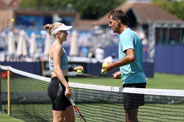 Harriet Dart of Great Britain chats with coach Colin Beecher as she runs through a practice session on the outside courts