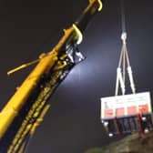 A carriage being lifted out by crane