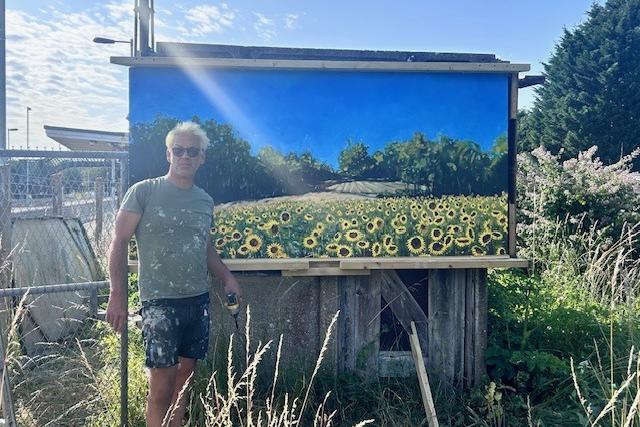 Grant Dejonge at Plumpton Station with his artwork