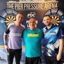 Brighton and Hove Albion goalkeeper Jason Steele (left) with world number two darts player Luke Humphries (right) and a Samaritans volunteer Dean. Photo: PDC/Samaritans