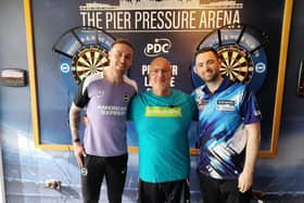 Brighton and Hove Albion goalkeeper Jason Steele (left) with world number two darts player Luke Humphries (right) and a Samaritans volunteer Dean. Photo: PDC/Samaritans