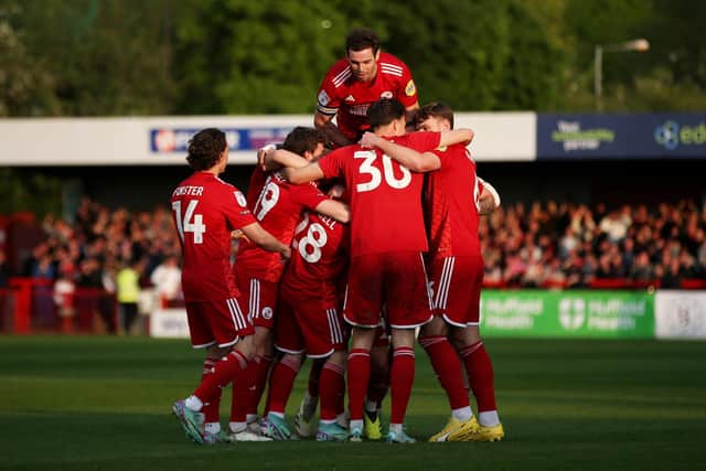 Liam Kelly of Crawley Town celebrates scoring his team's first goal with teammates during the Sky Bet League Two Play-Off Semi-Final 1st Leg match between Crawley Town and Milton Keynes Dons at Broadfield Stadium on May 07, 2024 in Crawley, England. (Photo by Steve Bardens/Getty Images)