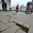 The poor state of pavements, showing a missing slab