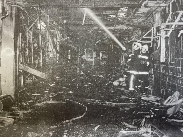 Firemen dampening the wreckage left behind.