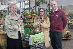 Emily Hamilton receives the donation from Craig Brookwell at Old Barn Garden Centre.