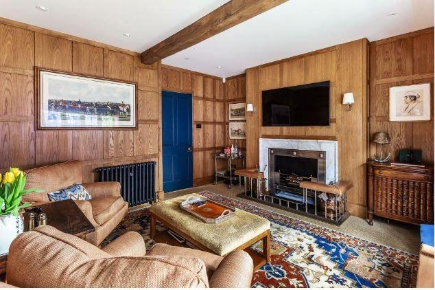 The cosy snug features wood-pannelled walls