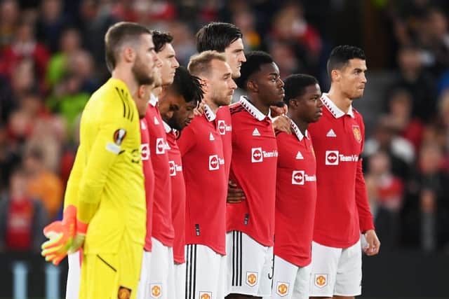 Players of Manchester United observe a minutes silence after it was announced that Queen Elizabeth II has passed away today prior to the UEFA Europa League group E match between Manchester United and Real Sociedad at Old Trafford on September 08, 2022 in Manchester, England. (Photo by Michael Regan/Getty Images)