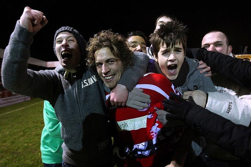 Goalscorer Sergio Torres celebrates victory with fans after the FA Cup win over Derby County at Broadfield Stadium on January 10, 2011.