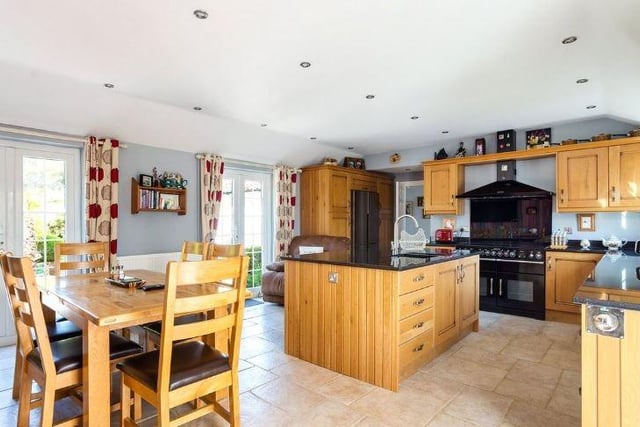 The airy and spacious kitchen/dining room has two French doors leading out to the garden