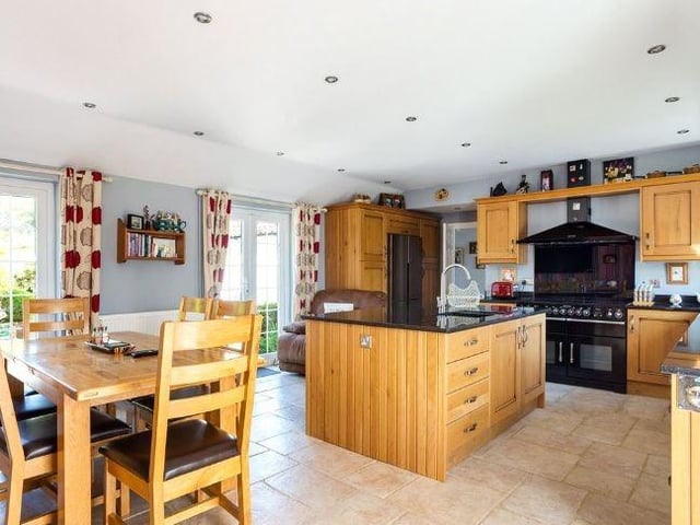The airy and spacious kitchen/dining room has two French doors leading out to the garden
