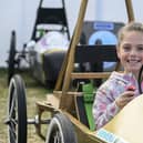A visitor checks out one of the Greenpower Education Trust's vehicles at the 2023 Festival of Speed.