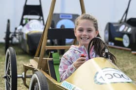 A visitor checks out one of the Greenpower Education Trust's vehicles at the 2023 Festival of Speed.