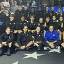 Zack Bull is bottom left as the ballkids pose with the great Roger Federer