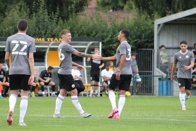 James Tilley and Kwesi Appiah celebrate a goal in the 5-0 win over Three Bridges. Picture by Cory Pickford