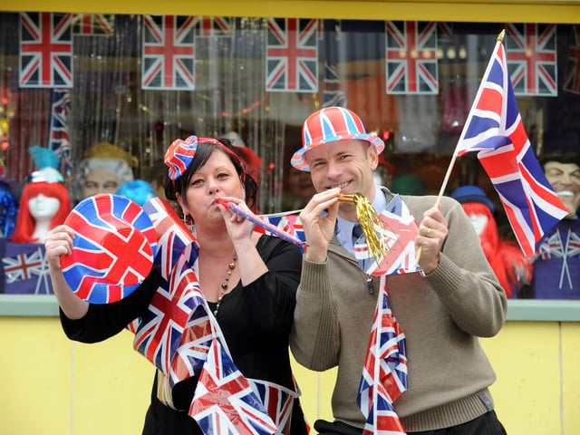 U-Need-Us staff (l-r) Tracey Knipe and Steve Searle help get the street party started outside the store in February 2011. Picture: Allan Hutchings (110573-233)