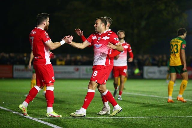 Nicky Cadden of Barnsley celebrates with teammate Herbie Kane after scoring the team's first goal during the Emirates FA Cup First Round Replay match between Horsham and Barnsley at The Camping World Community Stadium.