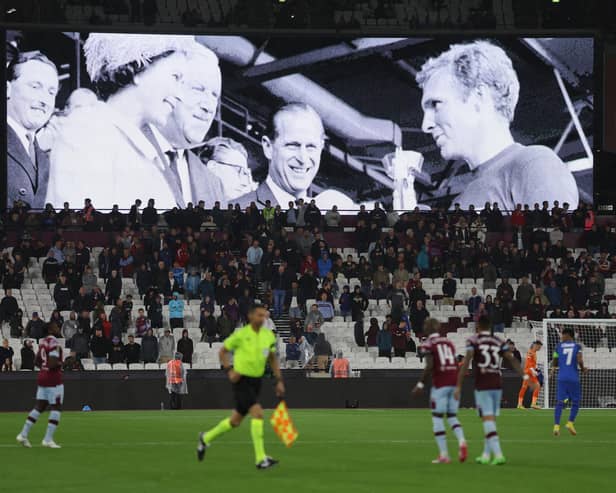The LED board shows the images of Queen Elizabeth II awarding the Jules Rimet World Cup Trophy to Bobby Moore after England won the 1966 World Cup final at Wembley, after it was announced that Queen Elizabeth II has passed away today during the UEFA Europa Conference League group B match between West Ham United and FCSB at London Stadium on September 08, 2022 in London, England. (Photo by Richard Heathcote/Getty Images)