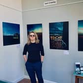 Photographer Sam Crawley in front of her work entitled "Grief and Freedom". Exhibiting during Artwave at "The Blue Shed" Venue no 91 in Lewes.