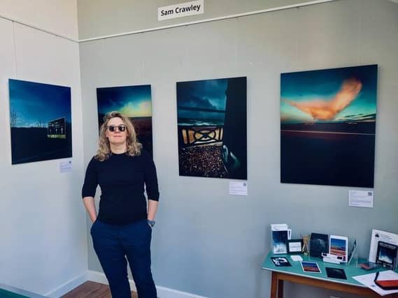 Photographer Sam Crawley in front of her work entitled "Grief and Freedom". Exhibiting during Artwave at "The Blue Shed" Venue no 91 in Lewes.