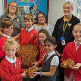 Community champion Alison Whitburn, manger Lisa Brockhurst and team leader Lynsey Porter from Morrisons Littlehampton deliver harvest loaves to Arundel Church of England School. Picture submitted.