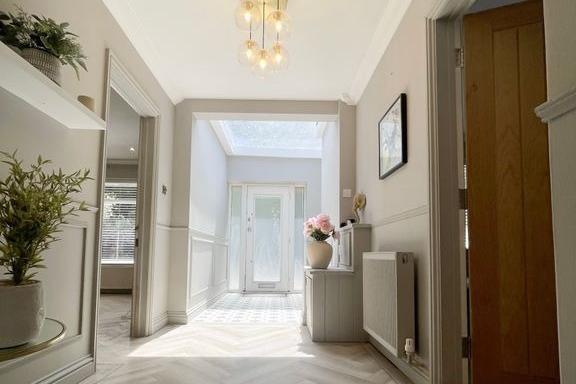 A spacious entrance hall welcomes you into the family home