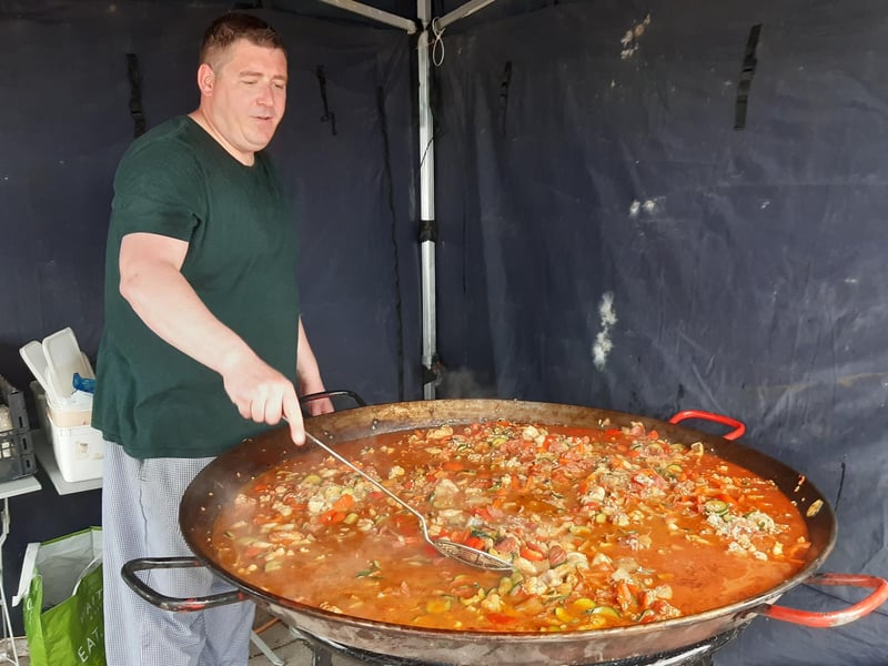 Glenn Slark cooking up seafood paella for the crowds