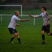 Players congratulating Bexhill Utd goal hero Theo Coombs | Picture by Amy Marshall