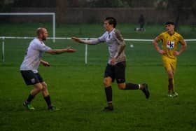 Players congratulating Bexhill Utd goal hero Theo Coombs | Picture by Amy Marshall