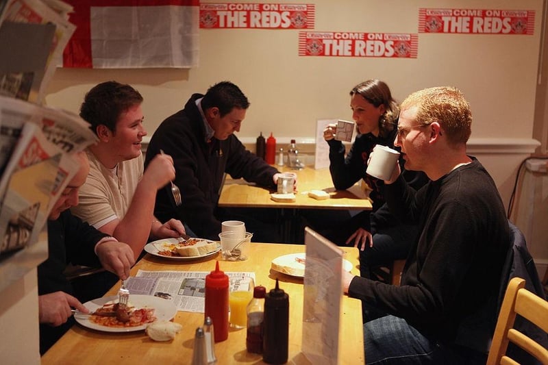 Crawley Town fans enjoy breakfast at the Pelham Buckle pub ahead of the trip to before boarding the coaches to Manchester.