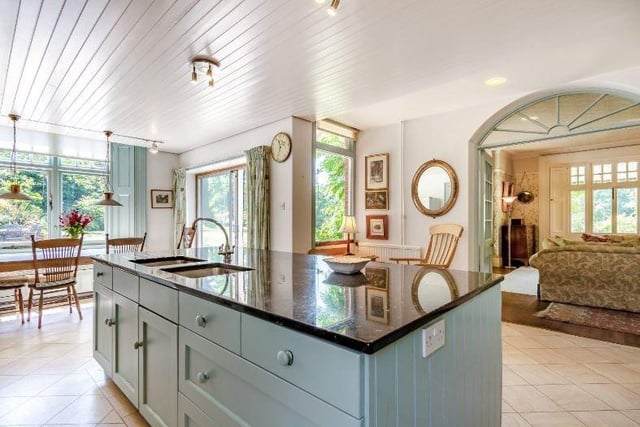Fitted with contemporary cabinetry, the bright and airy kitchen is centred on a green Aga, features an island unit and breakfast area with glazed sliding
doors to the garden.