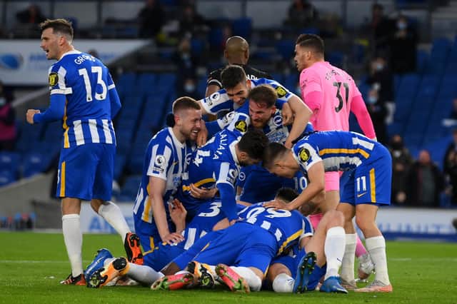Dan Burn of Brighton and Hove Albion celebrates after scoring their sides third goal with team mates during the Premier League match between Brighton & Hove Albion and Manchester City at American Express Community Stadium. (Photo by Mike Hewitt/Getty Images)