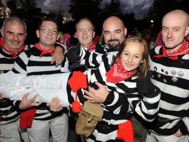 Burgess Hill Bonfire Night. Smuggler Chiana Barr gives the thumbs up, as she is held by her fellow smugglers