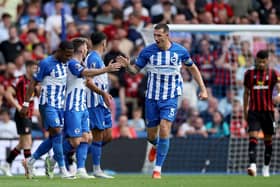 BRIGHTON, ENGLAND - SEPTEMBER 24: Lewis Dunk of Brighton & Hove Albion celebrates with teammates in a previous fixture against Bournemouth.