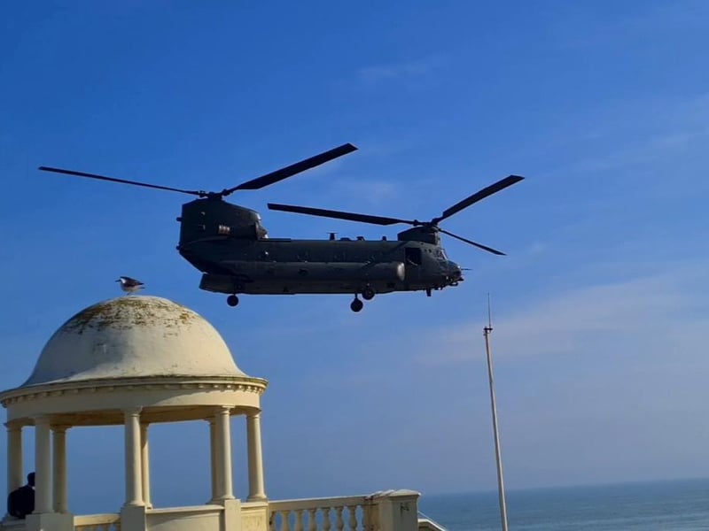A Boeing Chinook helicopter pictured over the Bexhill De La Warr Pavilion domes