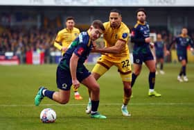 SUTTON, ENGLAND - DECEMBER 02: Joe Kizzi of Sutton United tackles Charlie Hester-Cook of Horsham during the Emirates FA Cup Second Round match between Sutton United and Barnsley at VBS Community Stadium on December 02, 2023 in Sutton, England. (Photo by Bryn Lennon/Getty Images)