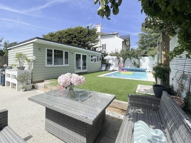 The landscaped garden cleverly accommodates areas for entertainment and play