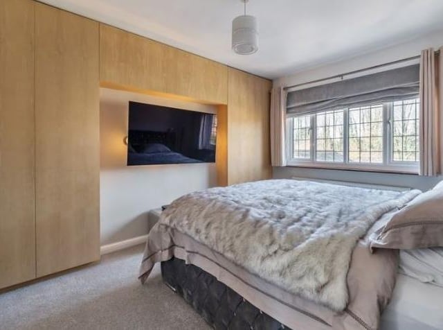On the first floor there is a bedroom with fitted wardrobes and ample storage