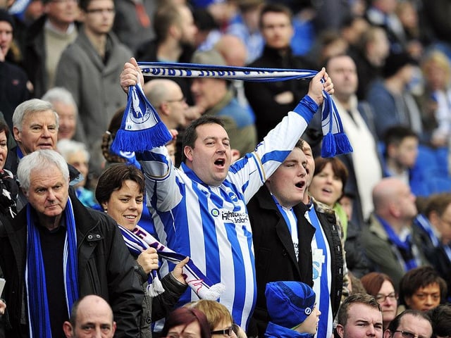 Brighton & Hove Albion's fans singing in the crowd ahead of the English FA Cup third round match between Brighton & Hove Albion and Newcastle United at The American Express Community Stadium on January 5, 2013.