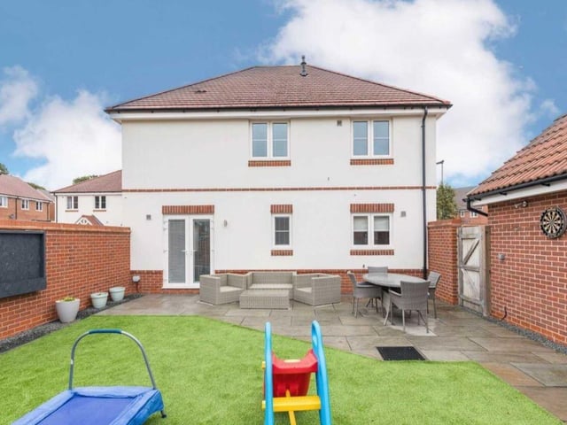 The rear garden has been landscaped by the current vendors and has a patio ideal for outdoor dining, an area of artificial grass, raised planter and shed.
