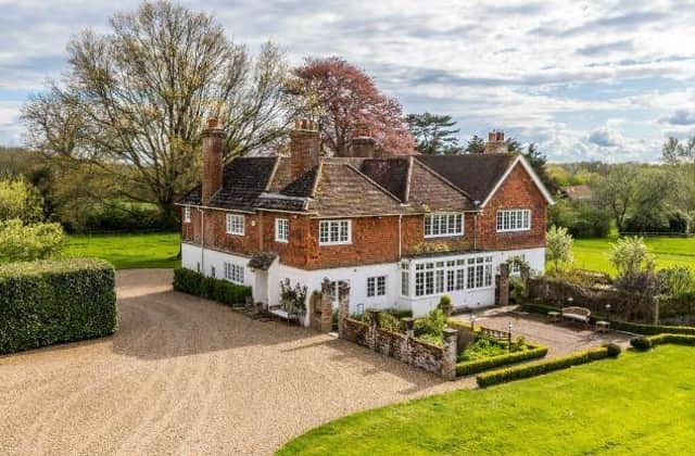This gorgeous six-bedroom family home has a separate cottage and a coach house with a flat above it