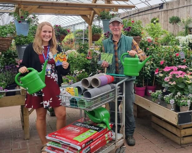 Hannah Wilson from Southway Junior School in Burgess Hill at South Downs Nurseries in Hassocks, collecting the gardening club donation from Clive Gravett, founder of the Budding Foundation. 