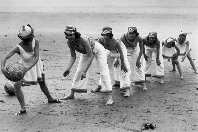 Pupils from Worthing Dancing School playing a game of ball on the beach in May 1934