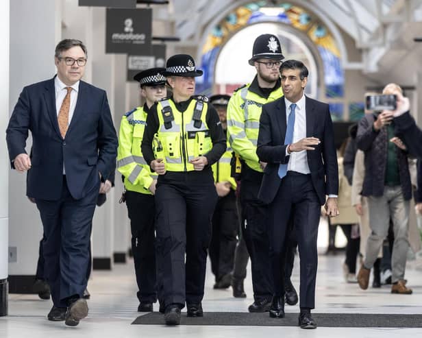 Prime Minister Rishi Sunk walks through Swan Walk shopping centre in Horsham, accompanied by local police officers. (Photo by Richard Pohle - WPA Pool/Getty Images)